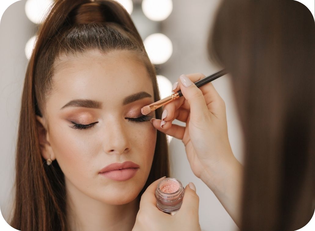 woman getting her makeup done