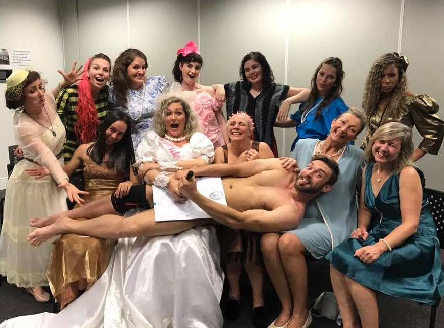 Hens in frilly retro dresses with the model across their laps