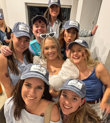 A hens group in matching caps squeezed in for a selfie