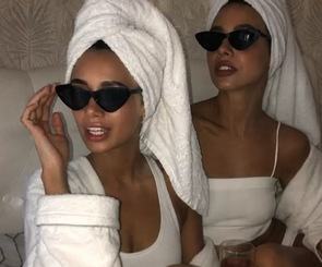 Two friends in white robes, towel turbans and sunglasses