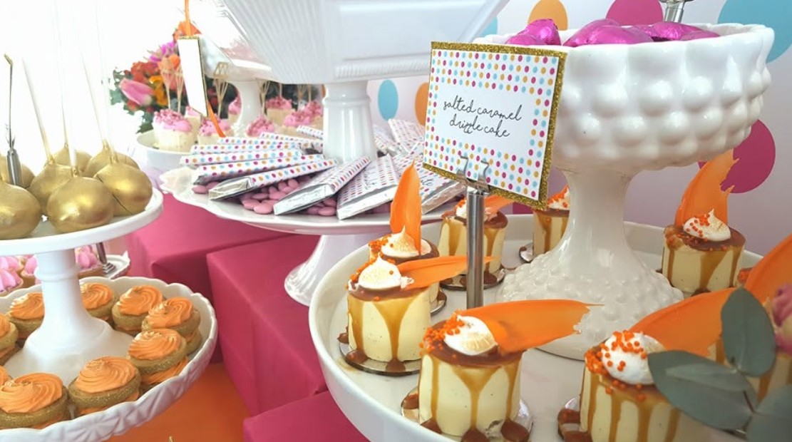 Little salted caramel drizzle cakes on a cake stand