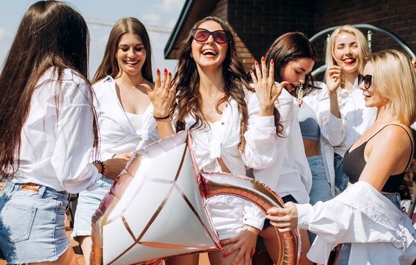 A gorgeous hen was having a great time with her closest friends while holding a large ring balloon for her hen party