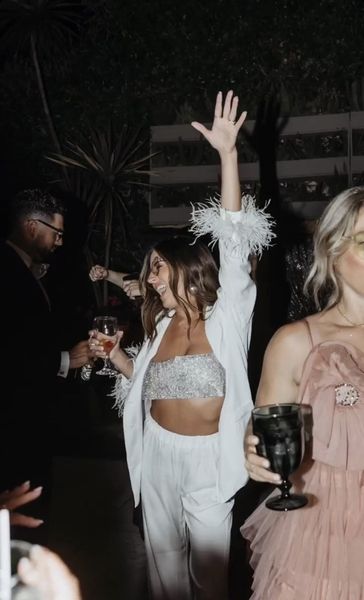 Friends dancing with arms raised at a night party