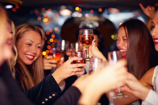 A gorgeous hen and her closest friends raise a wine toast and have fun together on the rooftop bar