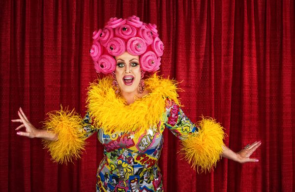 A fabulous drag queen in a bright dress, ready to perform
