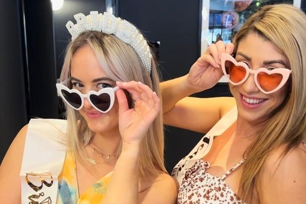 The bride and a friend in heart sunglasses showing off fresh glam