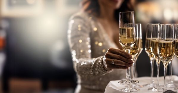 glam lady takes a glass of champagne on her hens night from a tray