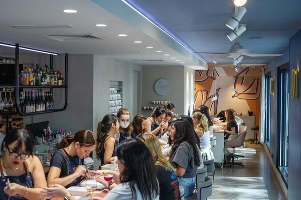 A big group having manicures together at a busy beauty bar