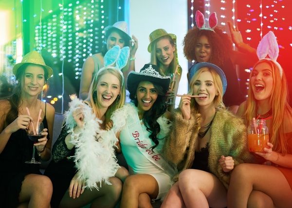 a group of best friends laughing and cheering in their reserved private seating