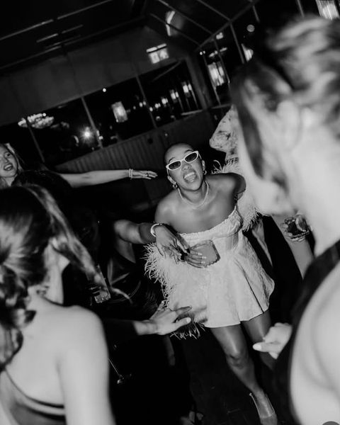 The bride to be dancing on a packed dance floor, in black and white