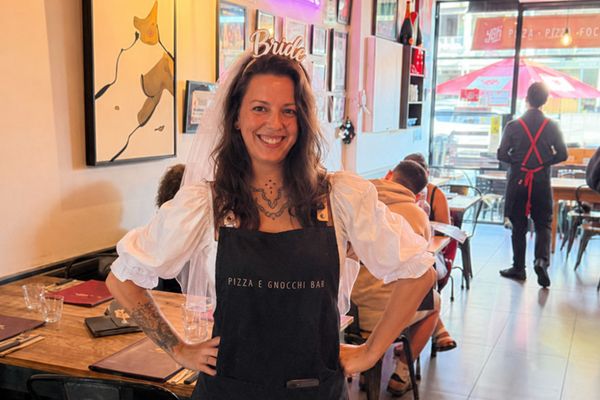 A bride to be in a Bride headband and apron smiling in a gnocchi bar