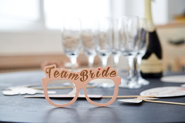 Team Bride glasses on a table set with champagne flutes