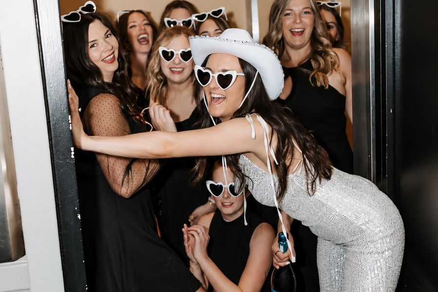 A hens group posing together in a lift on the way out