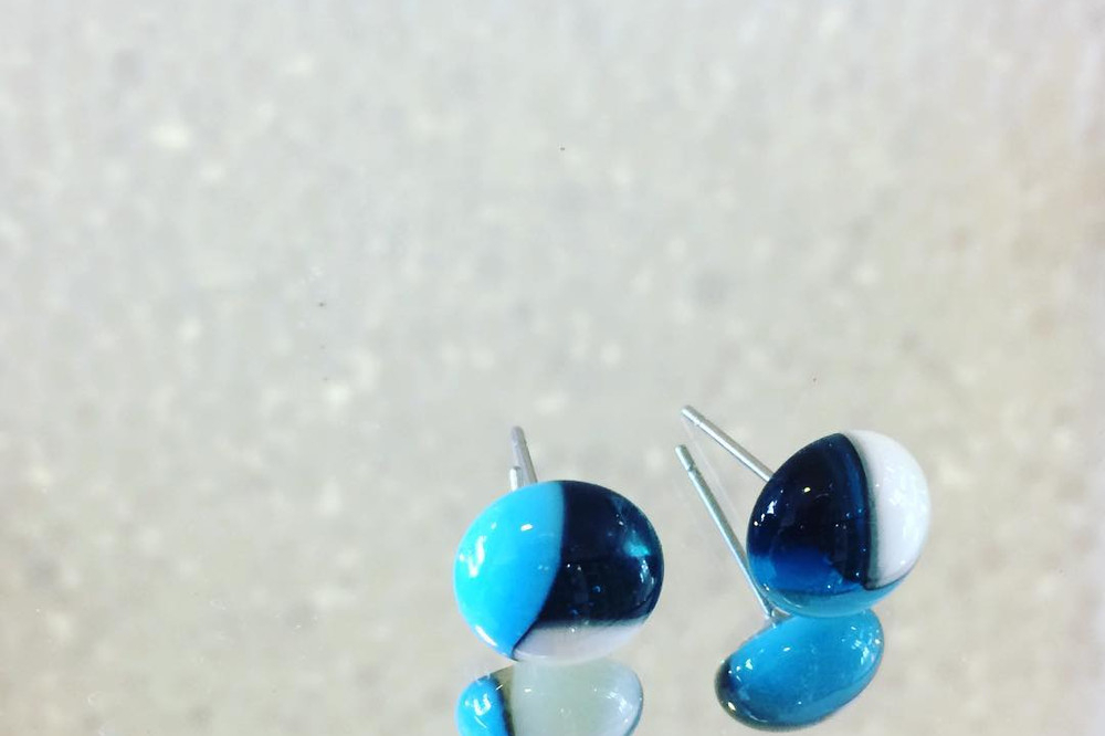 A pair of blue and white fused glass stud earrings made at a hens glass jewellery class