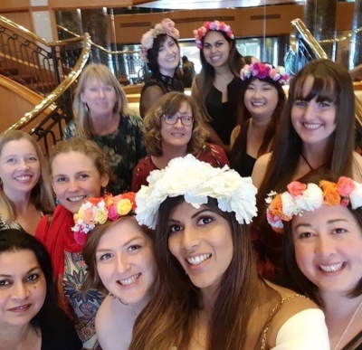 Amy and her hens crew in flower crowns squeezed into a laughing selfie on her winery day