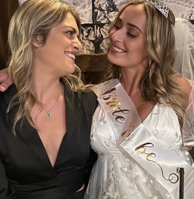 The bride in a Bride to be sash with a friend, from this hens group's own photos