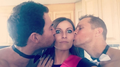Two topless waiters kissing the cheeks of a guest in a sash, sent in with this review