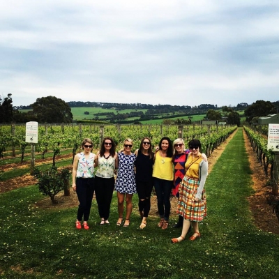 Amanda's hens group standing together between the rows of a Hunter Valley vineyard